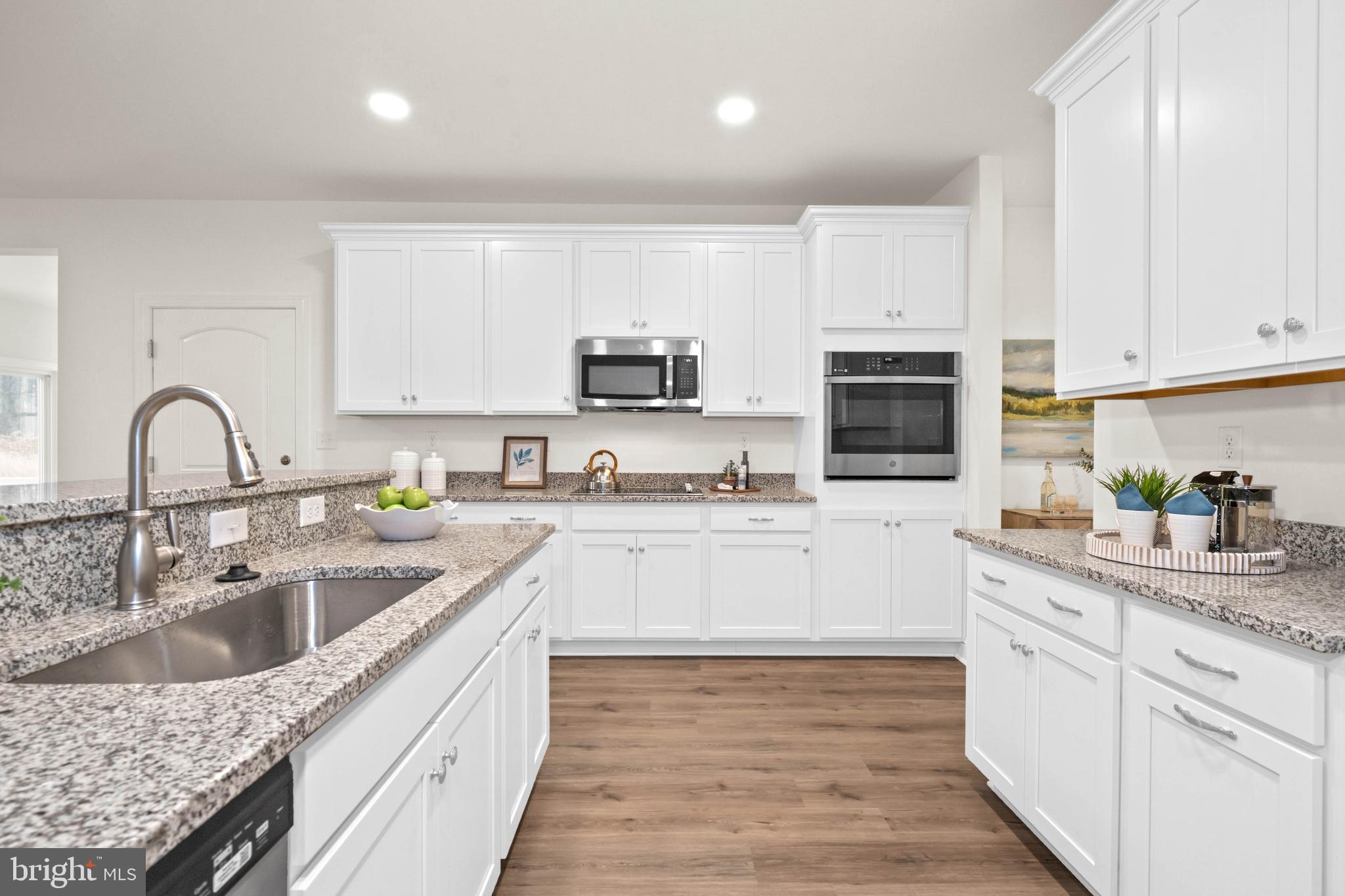 548 Longhorn Loop Middletown, DE 19709 - Photo 11 of 38 a kitchen with sink a microwave and cabinets