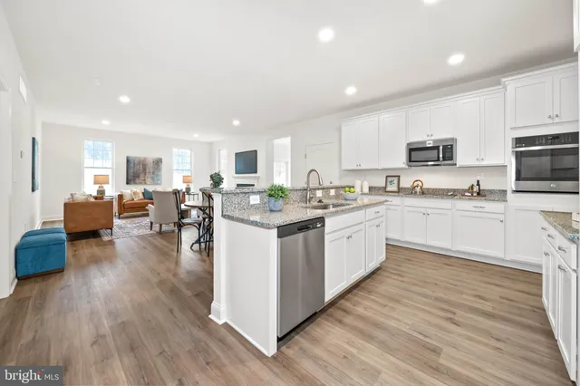 a kitchen with counter top space a sink cabinets and appliances