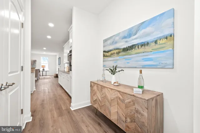 a view of hallway with wooden floor