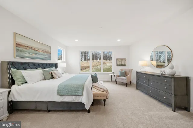 a bedroom with a large bed and furniture