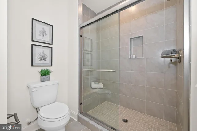 a bathroom with a shower a toilet and a sink