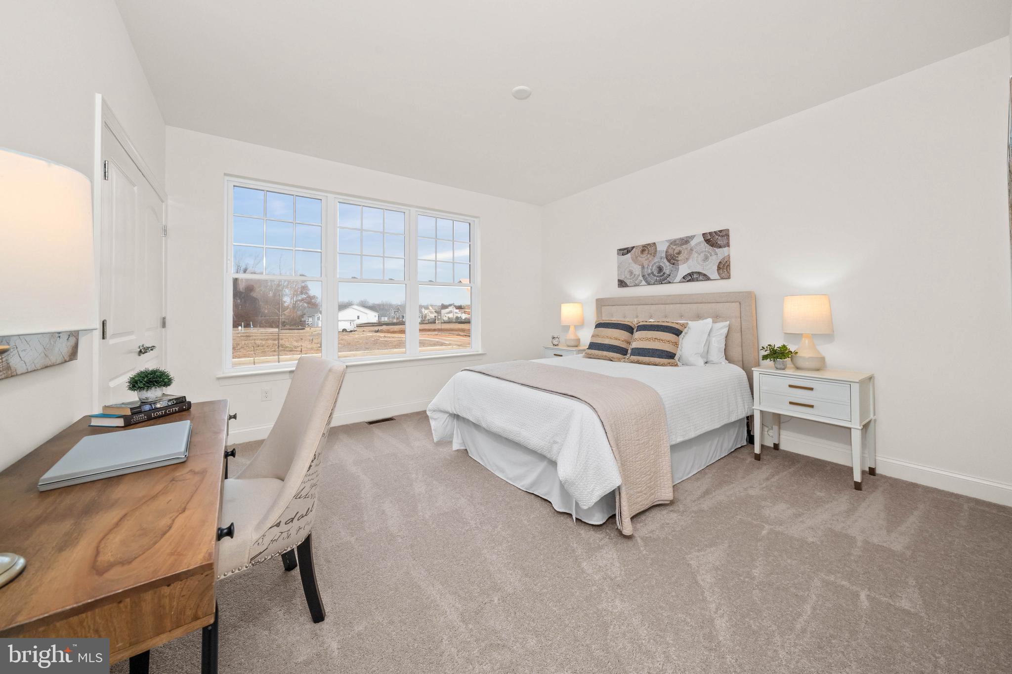 548 Longhorn Loop Middletown, DE 19709 - Photo 24 of 38 a bedroom with a bed and a window