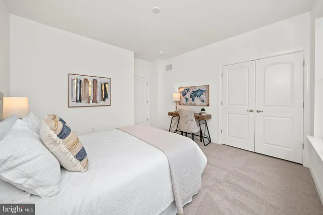 a bed room with a bed and a chair