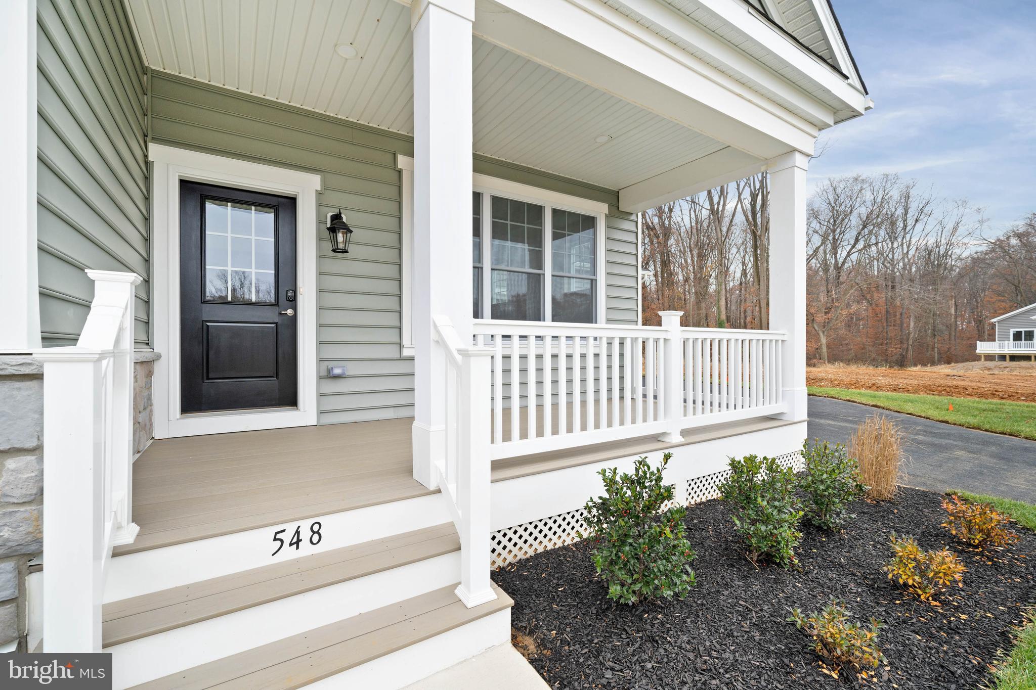 548 Longhorn Loop Middletown, DE 19709 - Photo 4 of 38 a view of a house with a small yard and wooden floor and fence