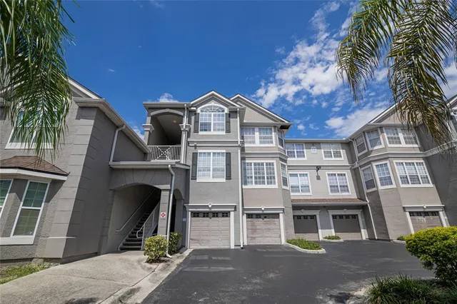 a front view of a house with a tree