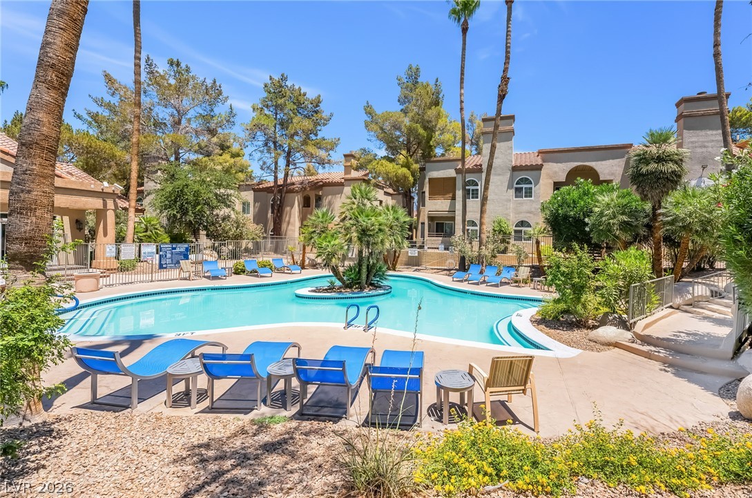 3145 East Flamingo Road, Unit 1092 Las Vegas, NV 89121 - Photo 28 of 33 A refreshing outdoor community pool awaits with ample space for relaxation and enjoyment.