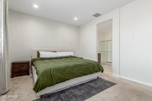 a bedroom with a bed and dresser