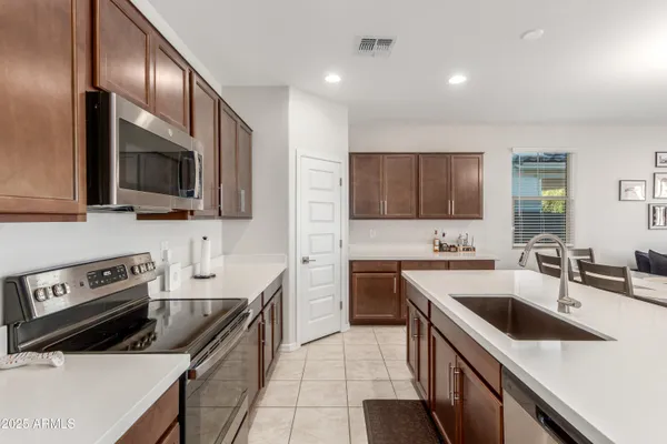 a kitchen with a sink a stove and cabinets