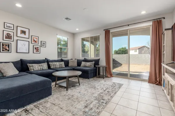 a living room with furniture and a glass door