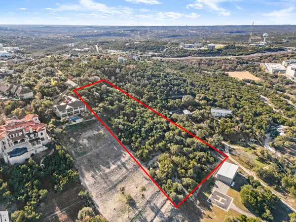 an aerial view of residential building with green space