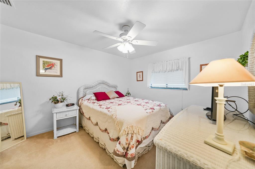 25225 Rampart Boulevard, Unit 1607 Punta Gorda, FL 33983 - Photo 15 of 48 a bedroom with a bed and a chandelier