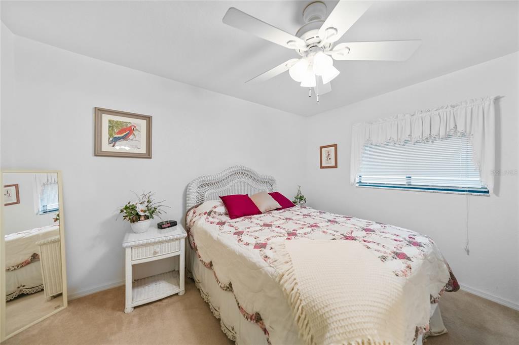 25225 Rampart Boulevard, Unit 1607 Punta Gorda, FL 33983 - Photo 16 of 48 a bedroom with a bed and a chandelier
