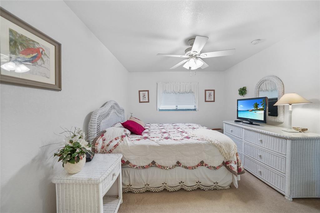 25225 Rampart Boulevard, Unit 1607 Punta Gorda, FL 33983 - Photo 18 of 48 a bedroom with a bed and a chandelier