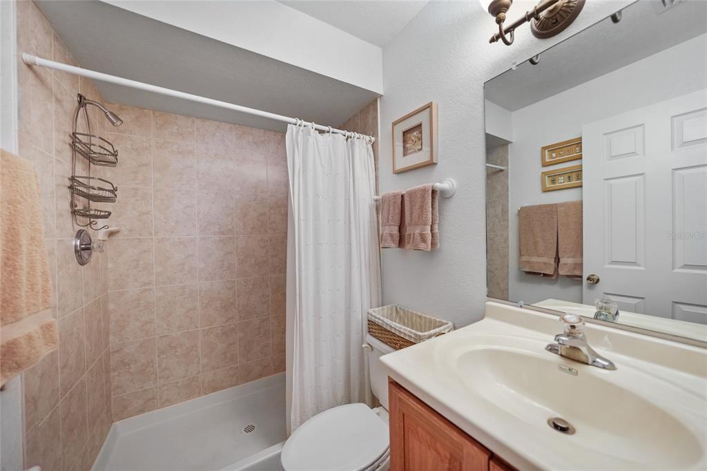 25225 Rampart Boulevard, Unit 1607 Punta Gorda, FL 33983 - Photo 19 of 48 a bathroom with a sink toilet and shower