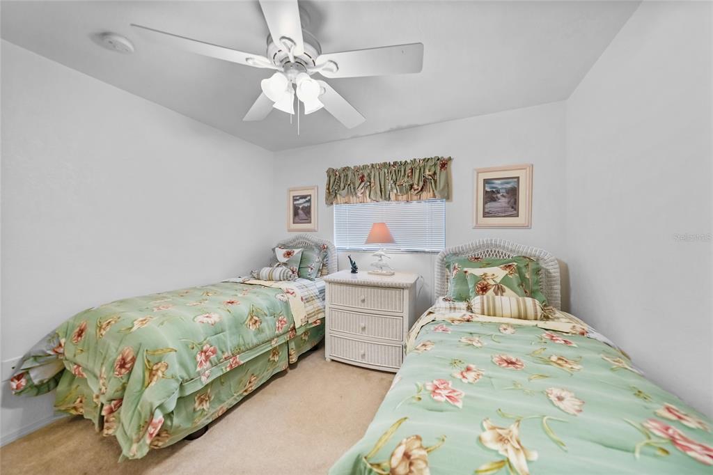 25225 Rampart Boulevard, Unit 1607 Punta Gorda, FL 33983 - Photo 21 of 48 a bedroom with a bed and a chandelier
