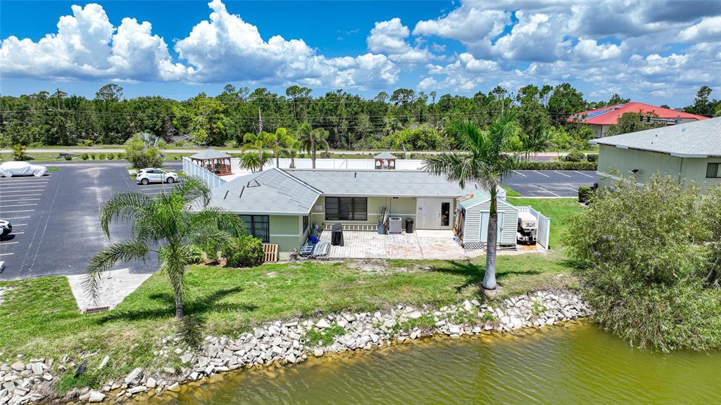 25225 Rampart Boulevard, Unit 1607 Punta Gorda, FL 33983 - Photo 39 of 48 a aerial view of a house with a big yard potted plants and large tree