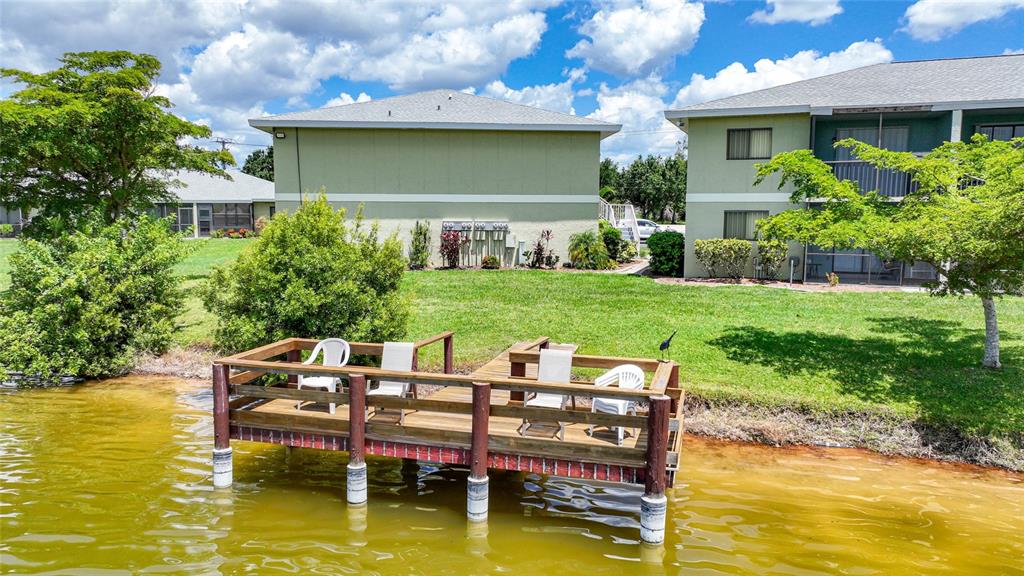 25225 Rampart Boulevard, Unit 1607 Punta Gorda, FL 33983 - Photo 43 of 48 a view of house with backyard outdoor seating and lake view