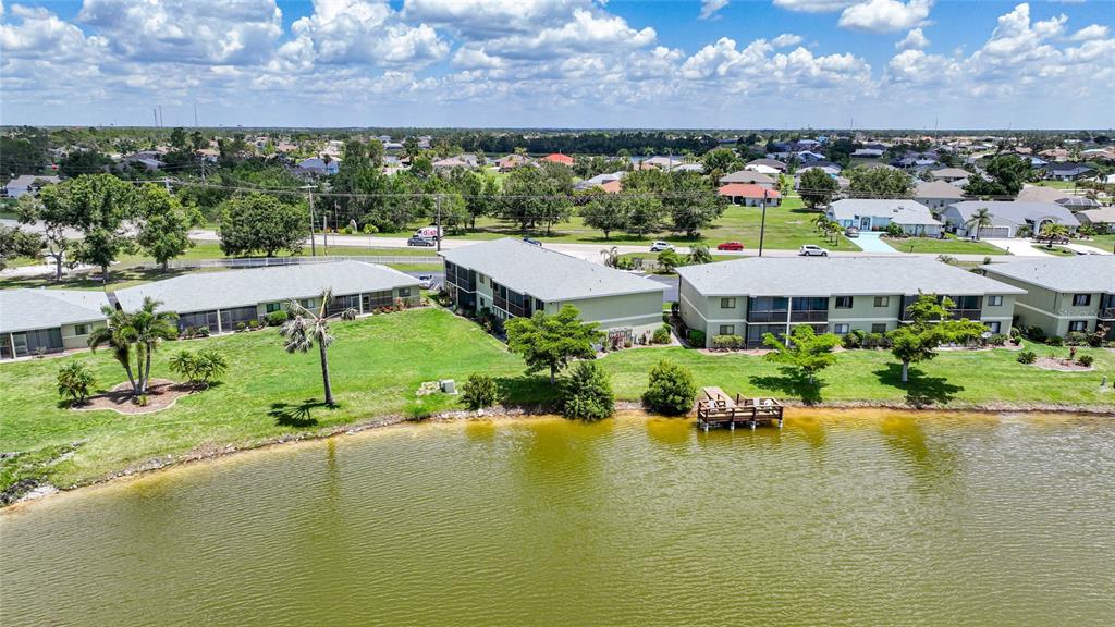 25225 Rampart Boulevard, Unit 1607 Punta Gorda, FL 33983 - Photo 46 of 48 an aerial view of a house with a garden and lake view