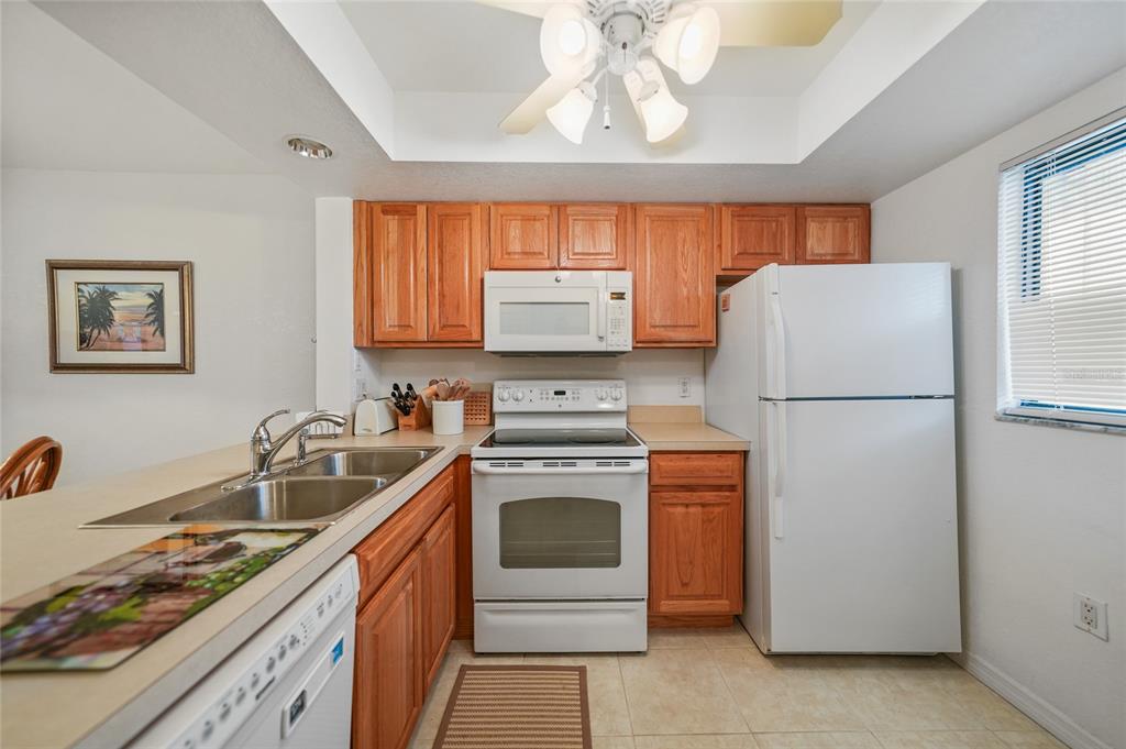 25225 Rampart Boulevard, Unit 1607 Punta Gorda, FL 33983 - Photo 6 of 48 a kitchen with granite countertop a refrigerator stove and sink