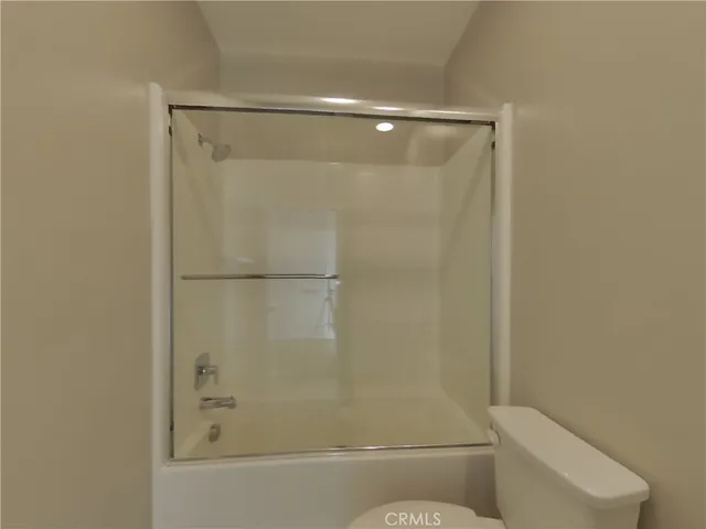 a bathroom with a shower and a toilet