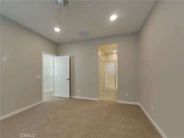 an empty room with windows and entrance