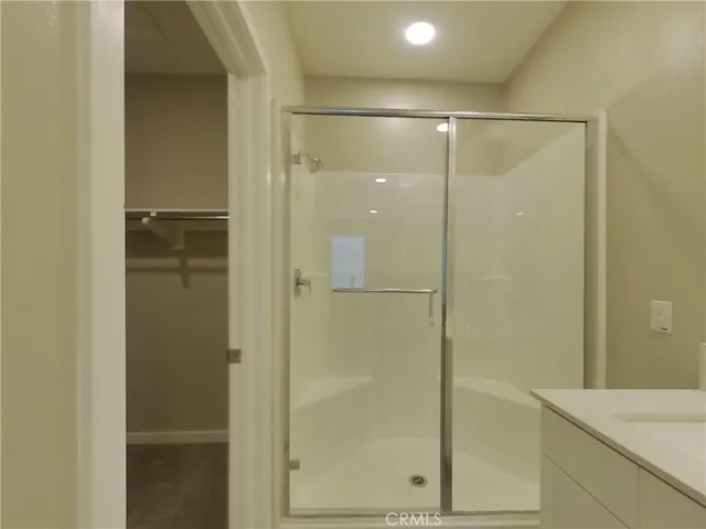 a bathroom with a glass shower door