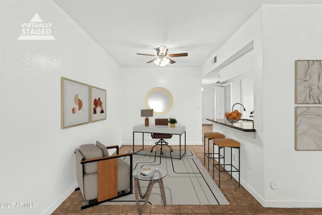 a living room with furniture a rug and a chandelier