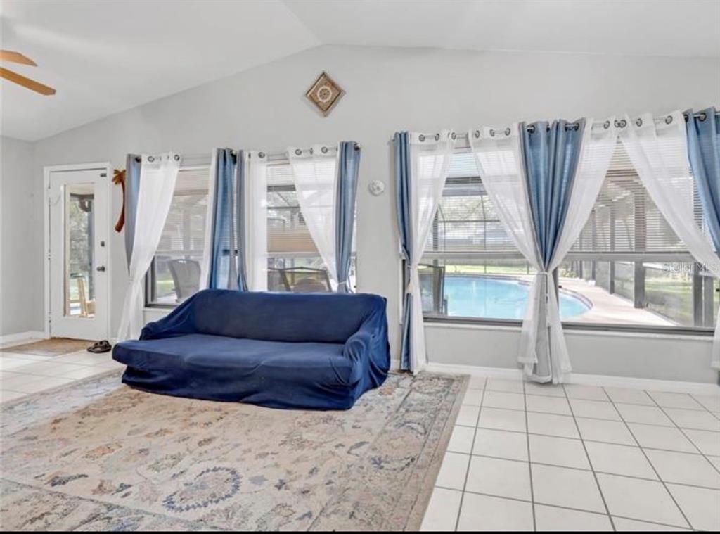 4308 Allen Road Fruitland Park, FL 34731 - Photo 12 of 33 a living room with furniture and a floor to ceiling window
