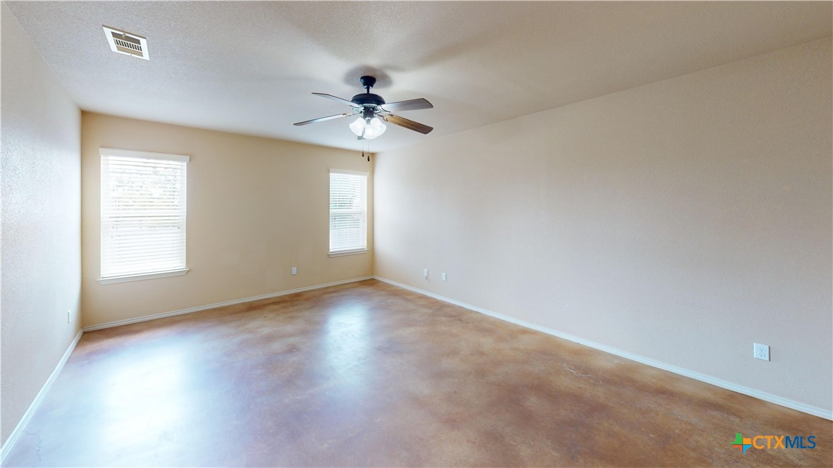 3401 Plateau Street Copperas Cove, TX 76522 - Photo 13 of 32 an empty room with wooden floor fan and windows
