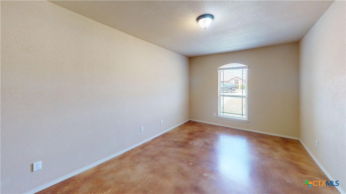 3401 Plateau Street Copperas Cove, TX 76522 - Photo 15 of 32 an empty room with wooden floor and windows