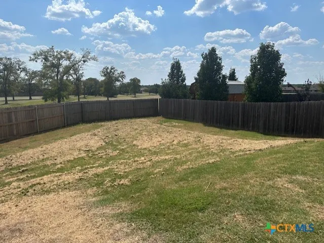 a front view of a house with a yard and a garage