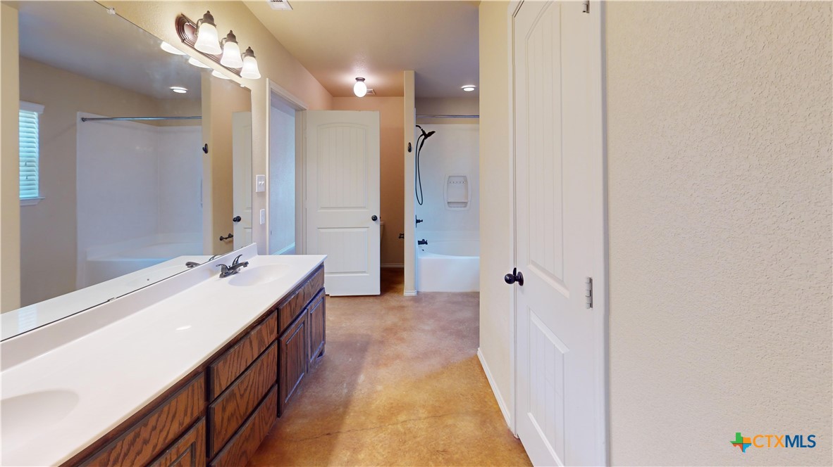 3401 Plateau Street Copperas Cove, TX 76522 - Photo 6 of 32 a bathroom with a tub sink and mirror