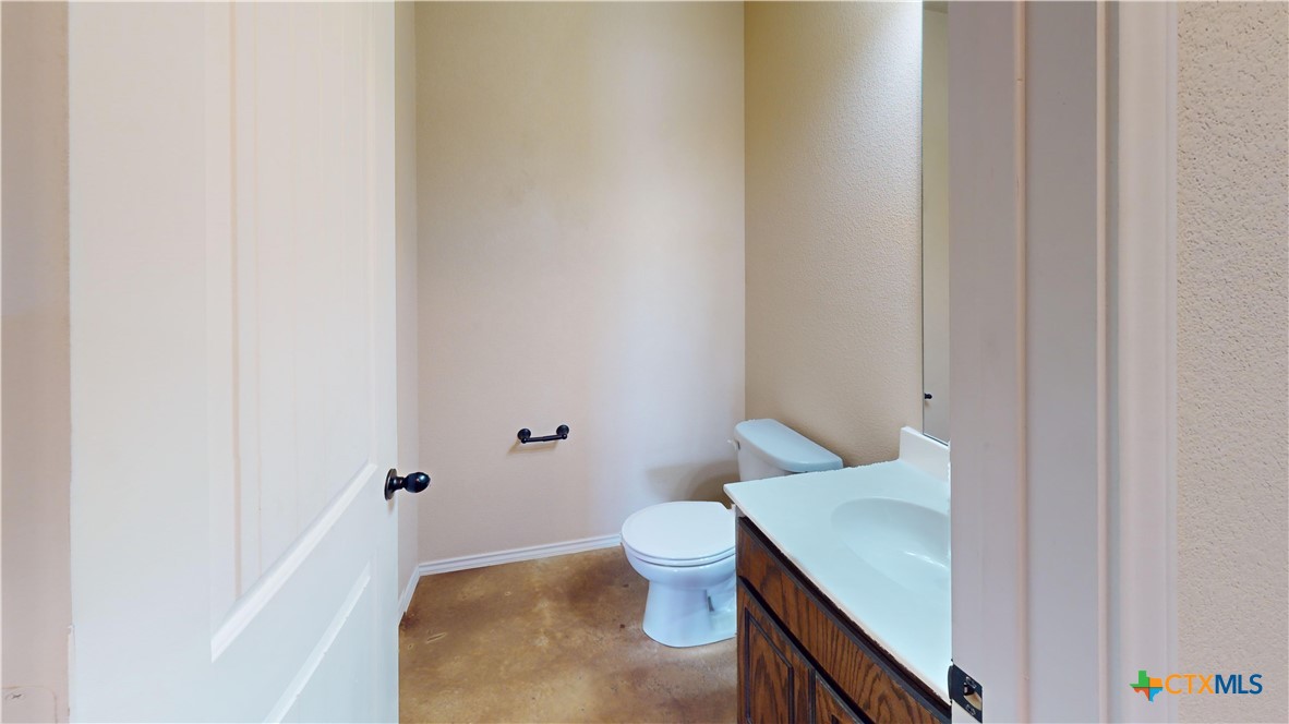3401 Plateau Street Copperas Cove, TX 76522 - Photo 8 of 32 a bathroom with a granite countertop sink and a toilet