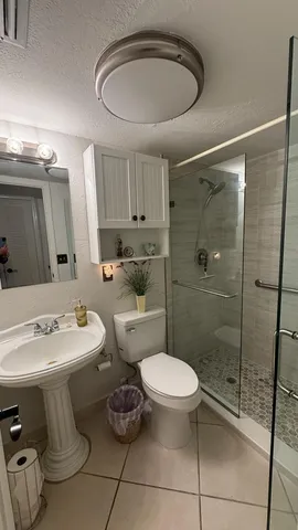 a bathroom with a toilet sink and shower