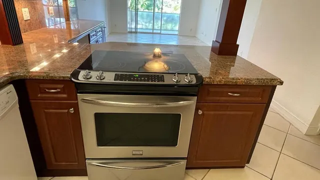 a stove top oven sitting inside of a kitchen