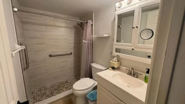 a bathroom with a sink toilet and shower