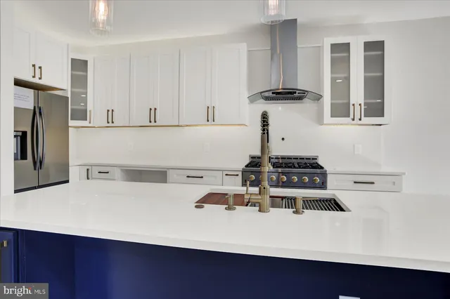 a kitchen with wooden floors and white cabinets