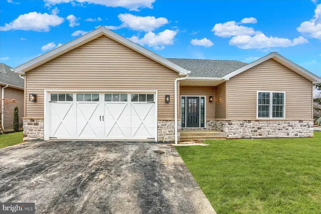 an empty room with wooden floor and a window