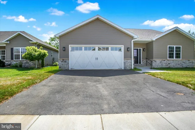 a view of a house with a yard and garage