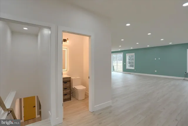a living room with furniture kitchen view and a large window