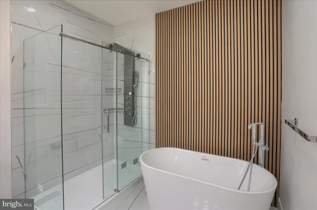 a view of an empty room with glass door and windows