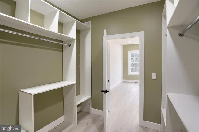 a view of hallway with wooden floor