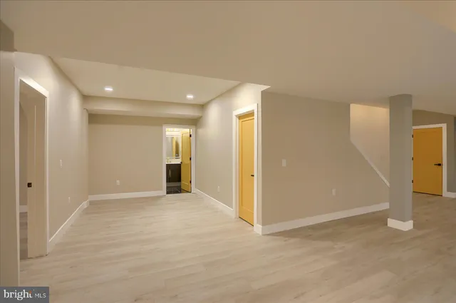 a view of a house with large windows and a road