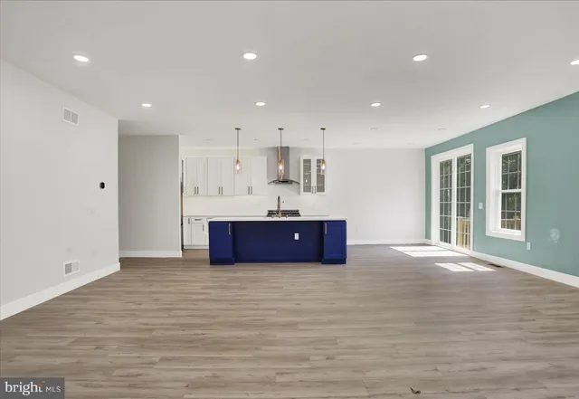a kitchen with a sink cabinets and wooden floor
