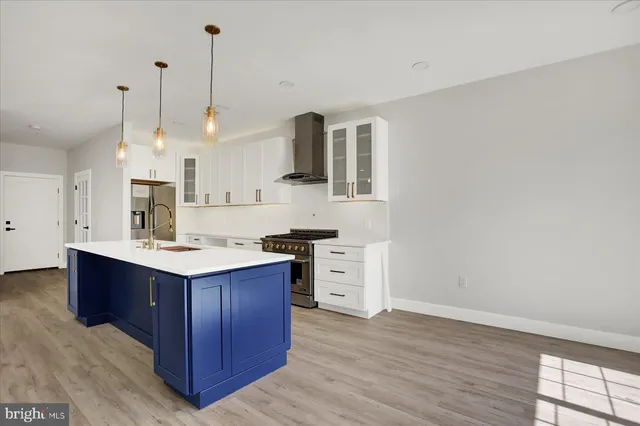 a view of a kitchen with a sink and chandelier