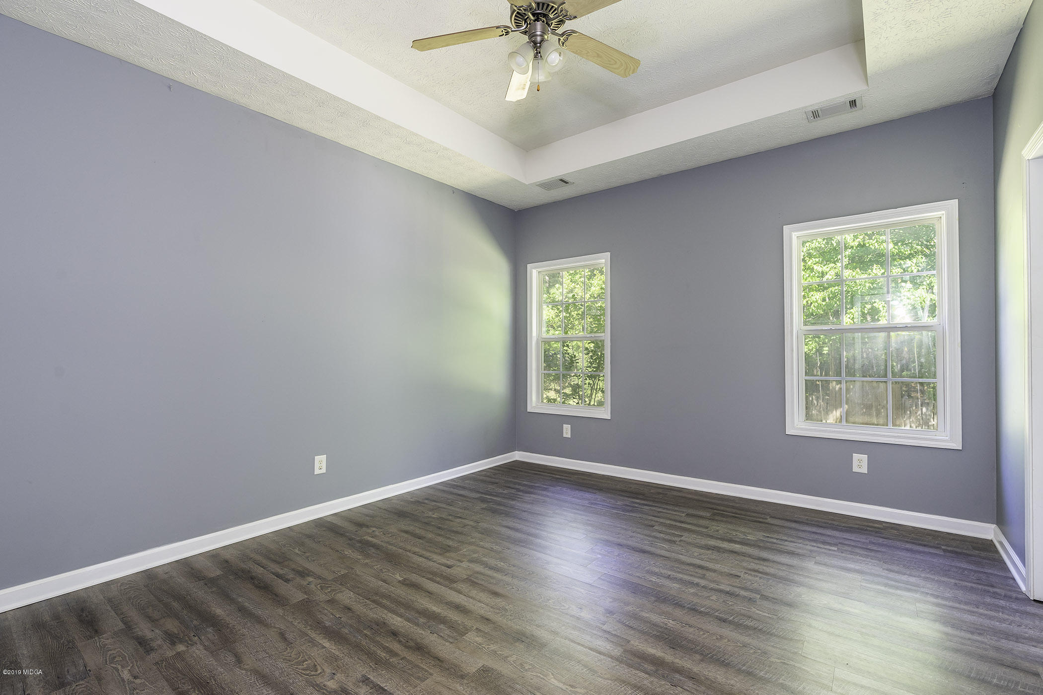 101 Hickory Road Jackson, GA 30233 - Photo 13 of 32 an empty room with a window and a ceiling fan