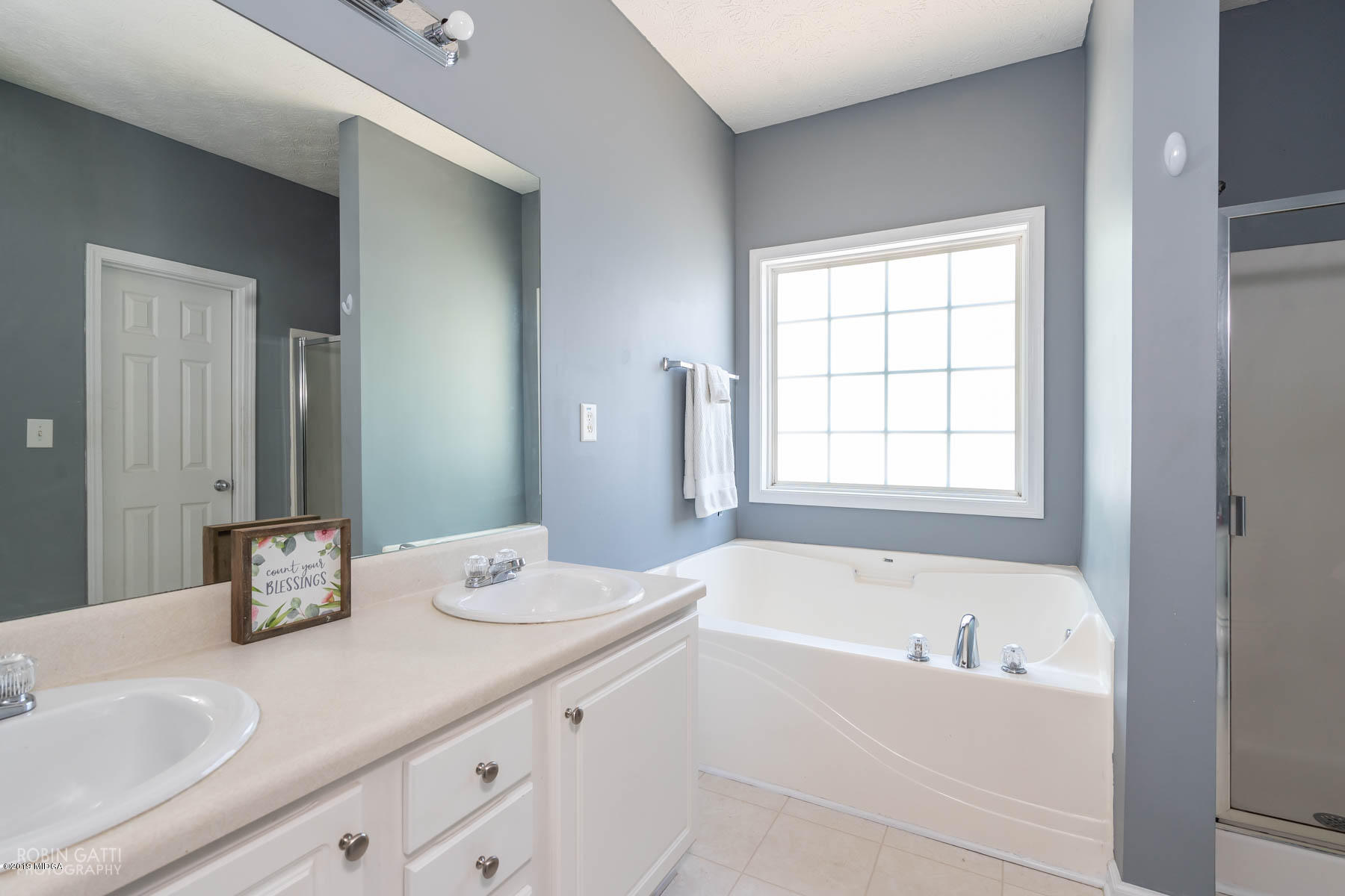 101 Hickory Road Jackson, GA 30233 - Photo 14 of 32 a bathroom with a granite countertop tub sink and mirror