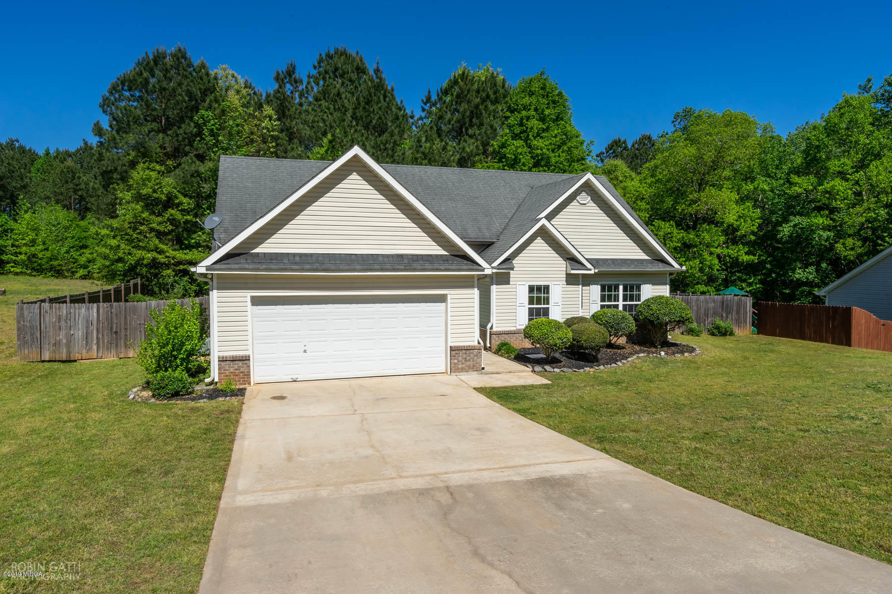 101 Hickory Road Jackson, GA 30233 - Photo 28 of 32 a front view of a house with a yard and garage