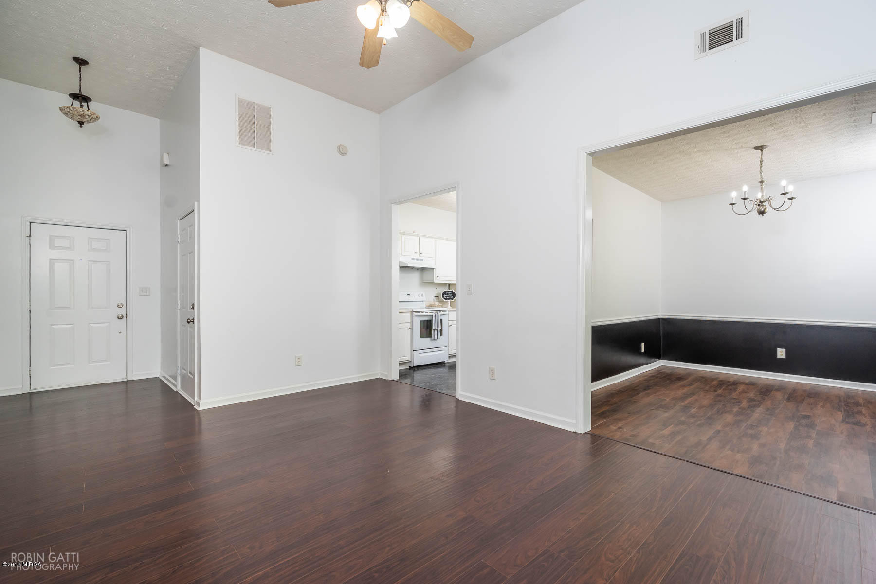 101 Hickory Road Jackson, GA 30233 - Photo 9 of 32 an empty room with wooden floor and chandelier