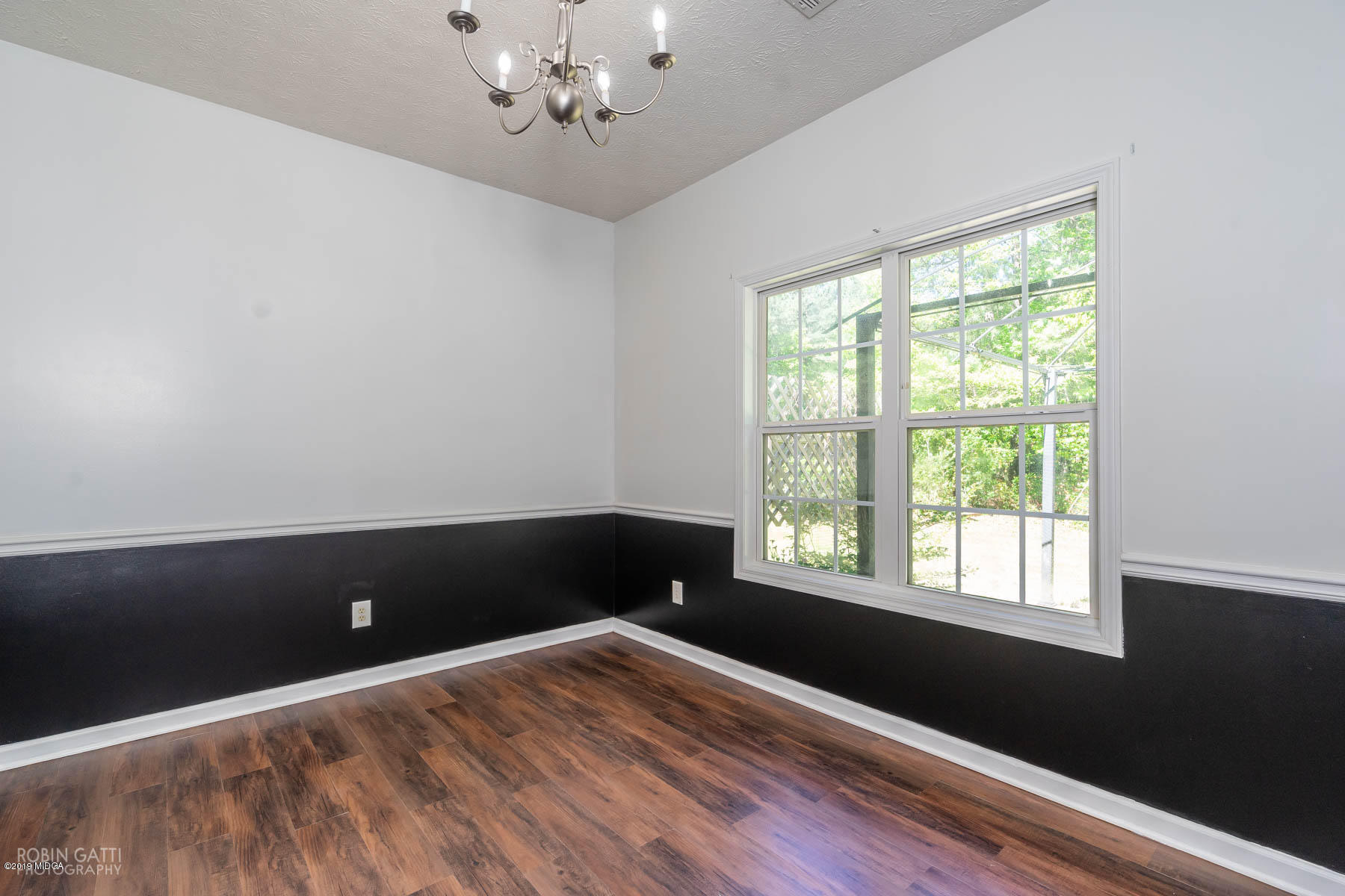 101 Hickory Road Jackson, GA 30233 - Photo 10 of 32 a view of an empty room with wooden floor and a window
